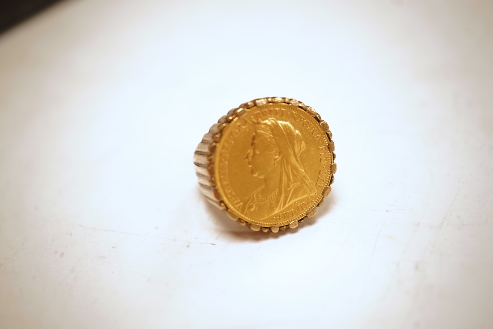 A sovereign ring, 1897 and later, set with a full sovereign dated 1897, to a fluted gold ring mount, size S (sizing band), ring mount stamped 9ct, gross weight 17 grams, Condition: typical surface wear